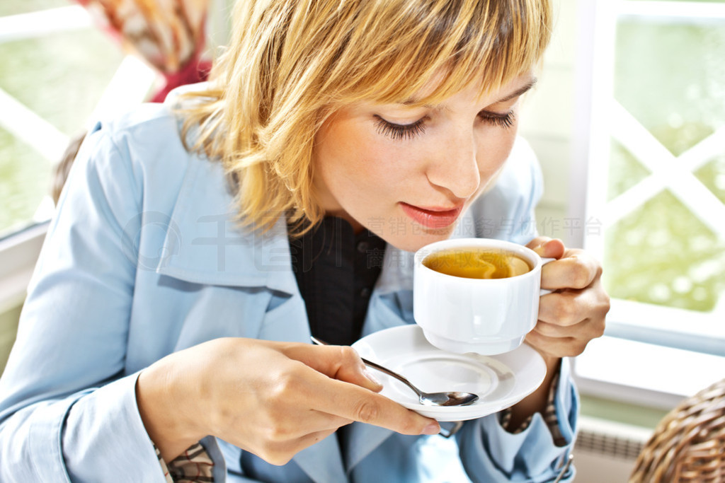 Women drinking in caf smiling