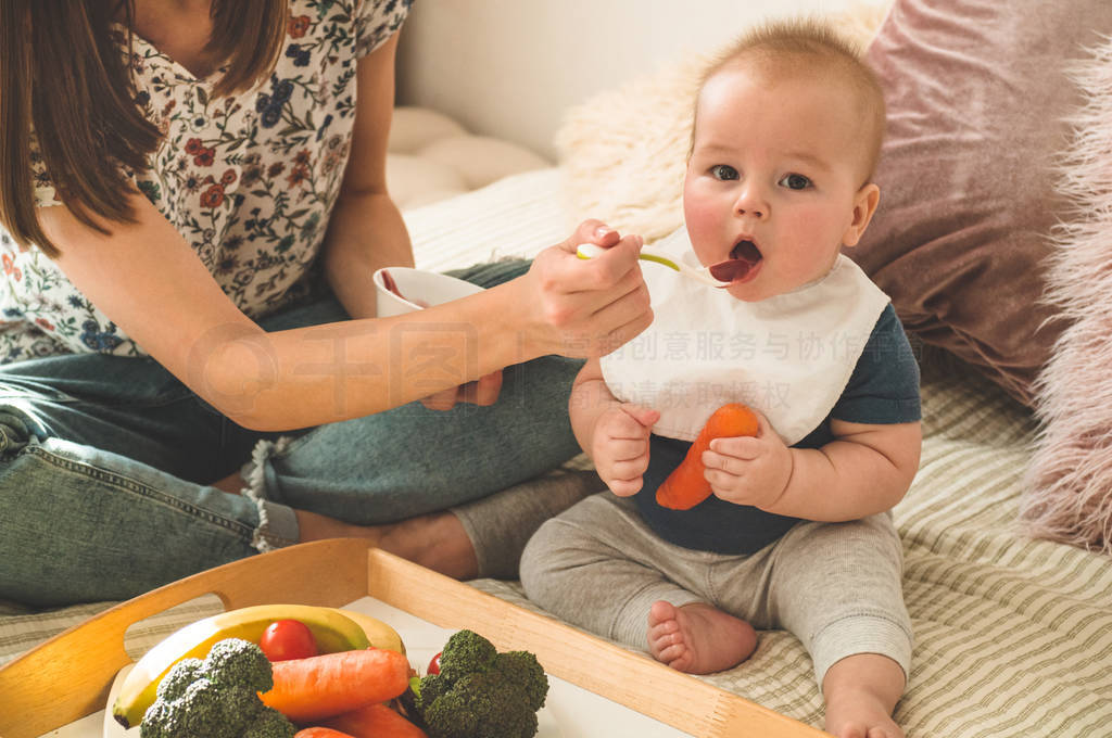 First solid food for young kid. Fresh organic carrot for vegetab