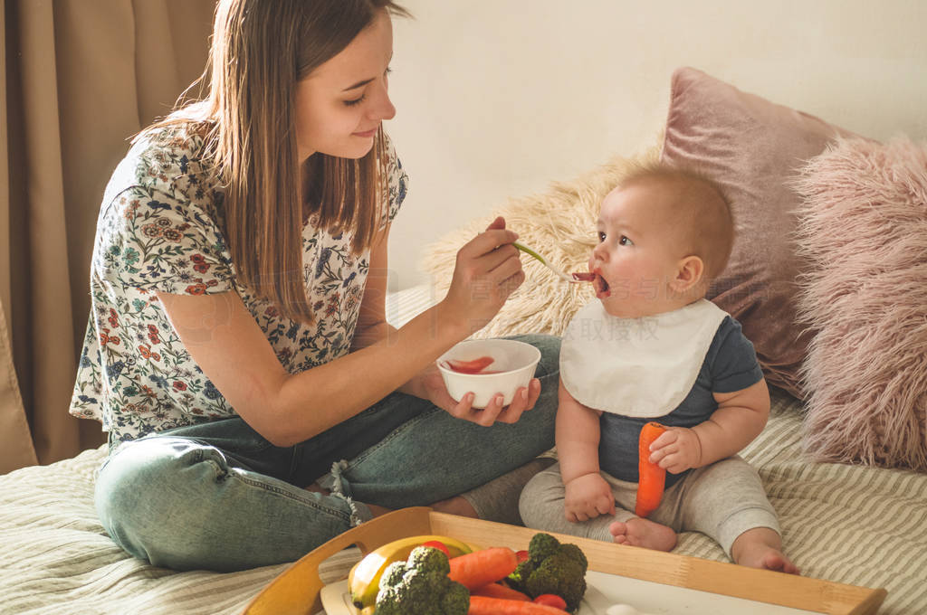 First solid food for young kid. Fresh organic carrot for vegetab