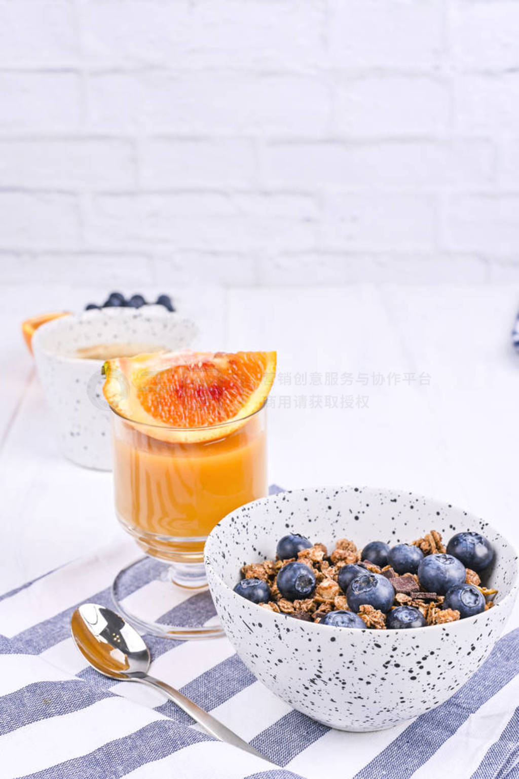 Breakfast on a white wooden background. Muesli with berries and