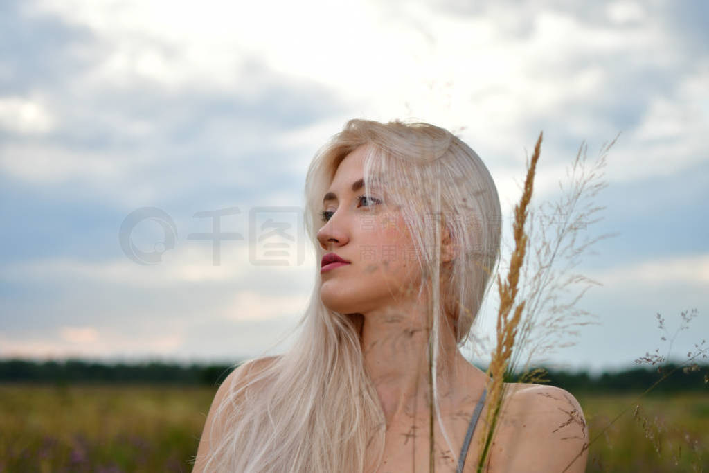 Closeup picture of perfect blonde pensive lady relaxing on heap