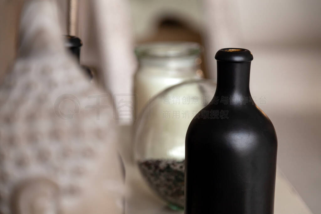 Black vintage opaque bottle for alcohol, wine stands on a table