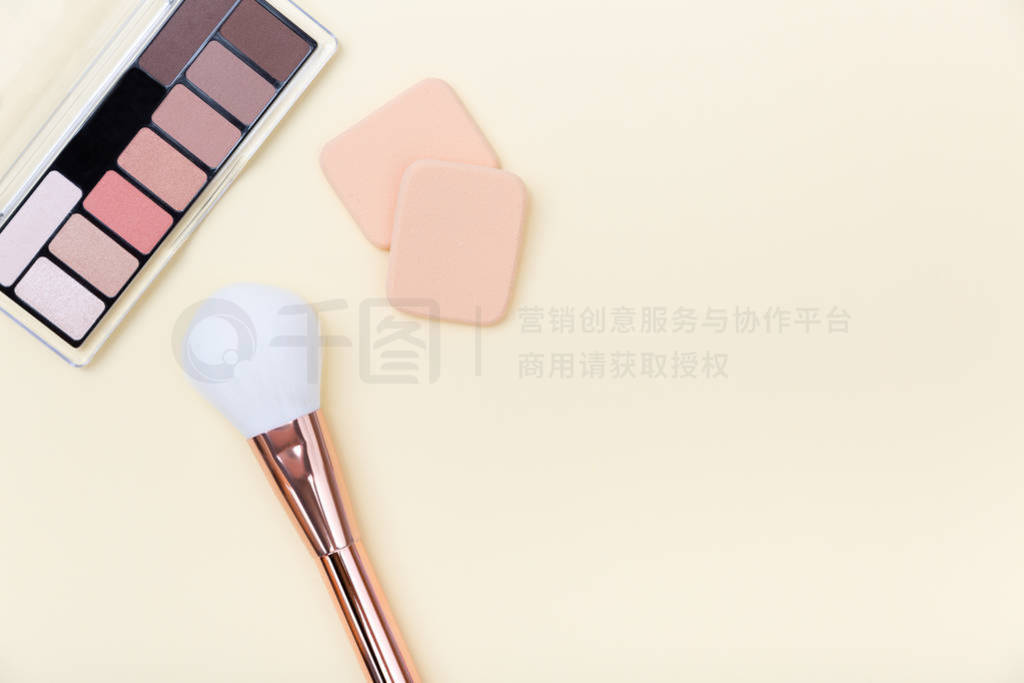 Decorative cosmetics, makeup products and brushes on light pink
