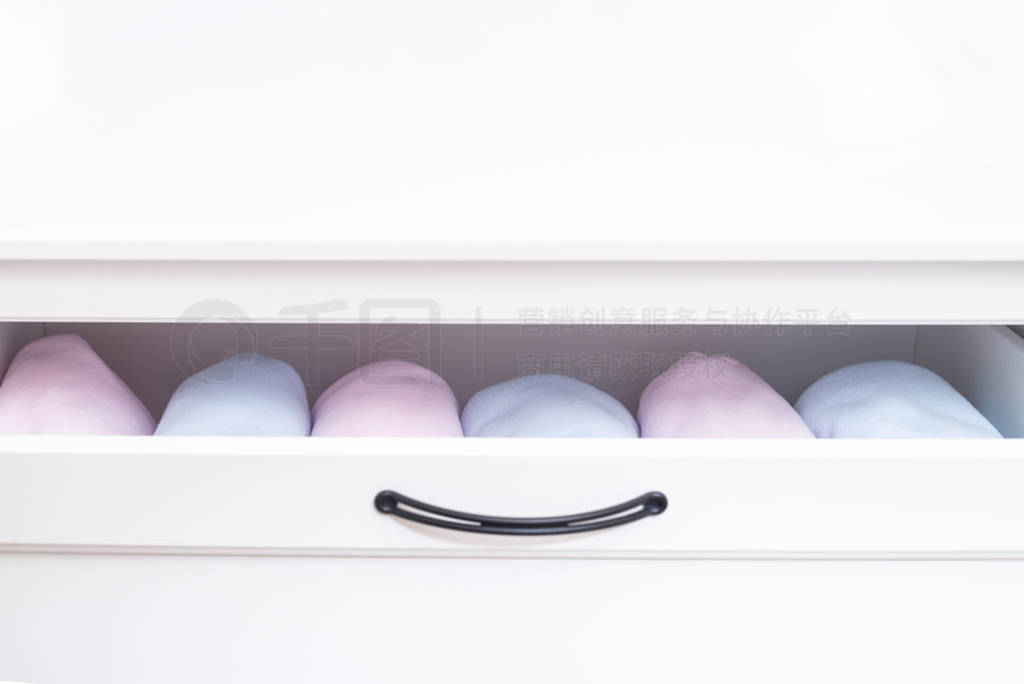 Set of baby clothes in cabinet drawer