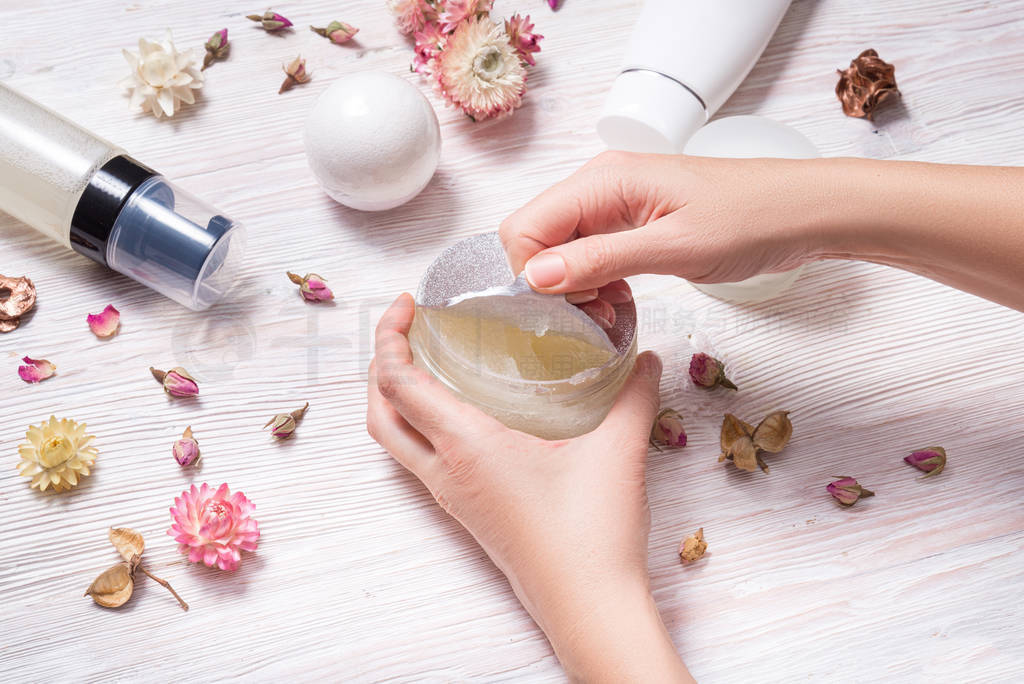 Woman hands opening cover face cream jar with aluminum foil