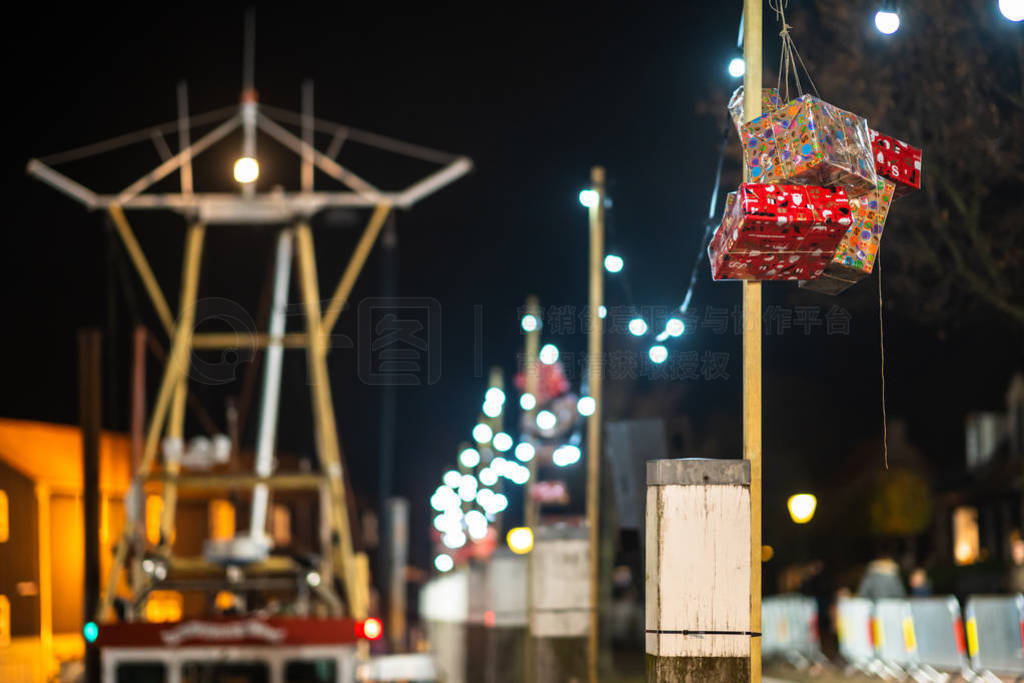 Sainta Claus presents with bulb lighting strings along the quay