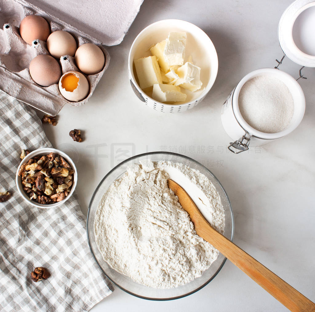 Ingredients for baking cake. Eggs, flour, sugar and whisk, butte