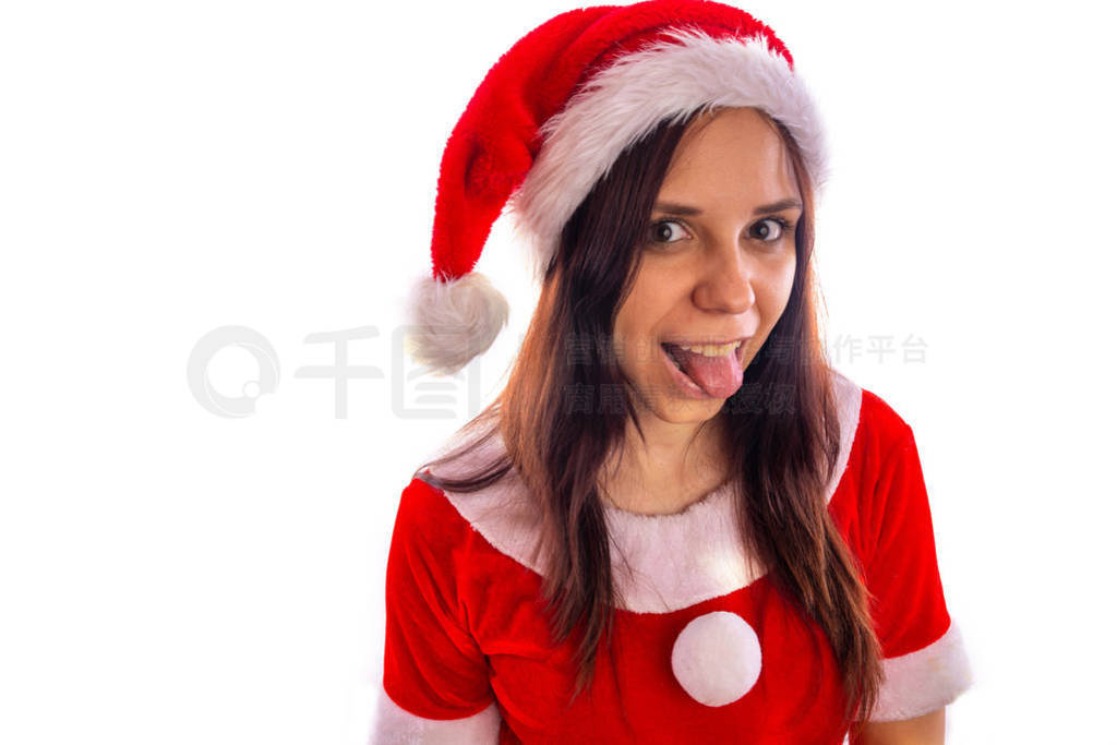 Smiling beautiful young woman in Santa Claus suit is looking at