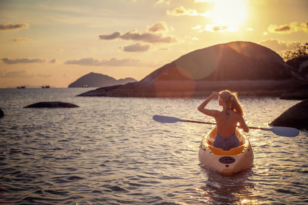 Girl on kayak sea at sunset, healthy lifestyle design. Sport,