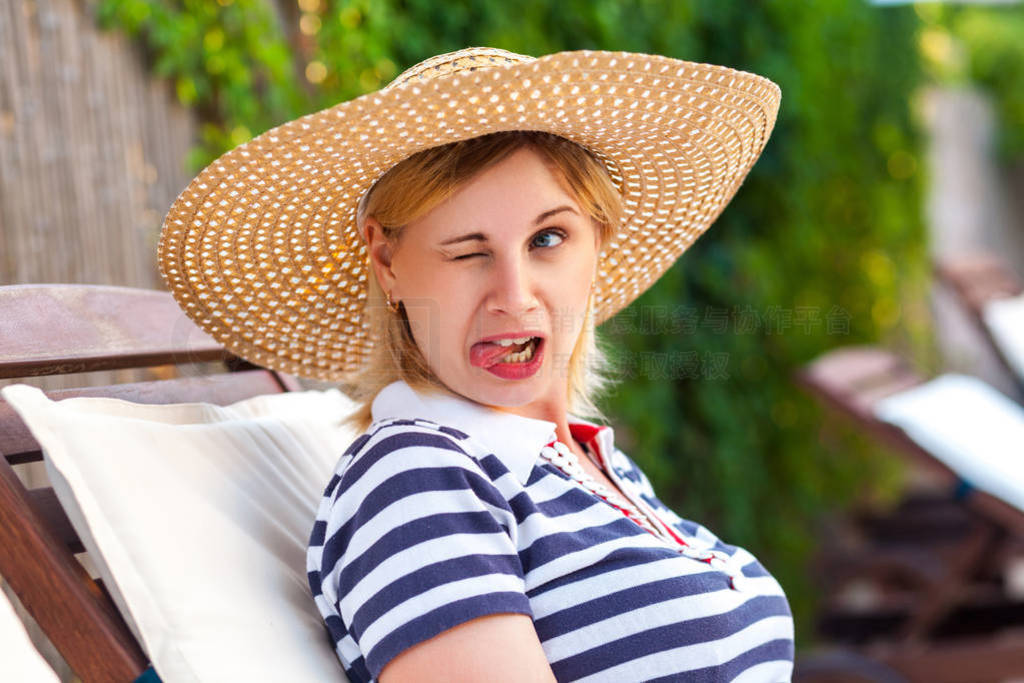 Portrait of funny grimace childish young adult woman in hat and