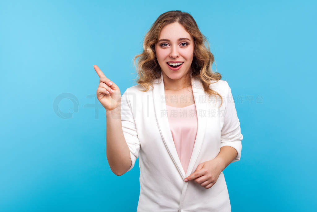 Portrait of wondered smart woman pointing finger up and looking