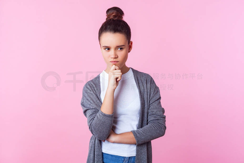 Portrait of smart pensive brunette teenage girl holding hand on