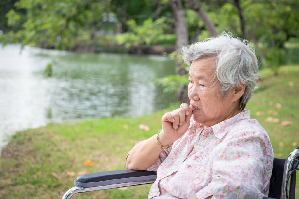 Asian senior woman feeling stressed,worried female bites finger