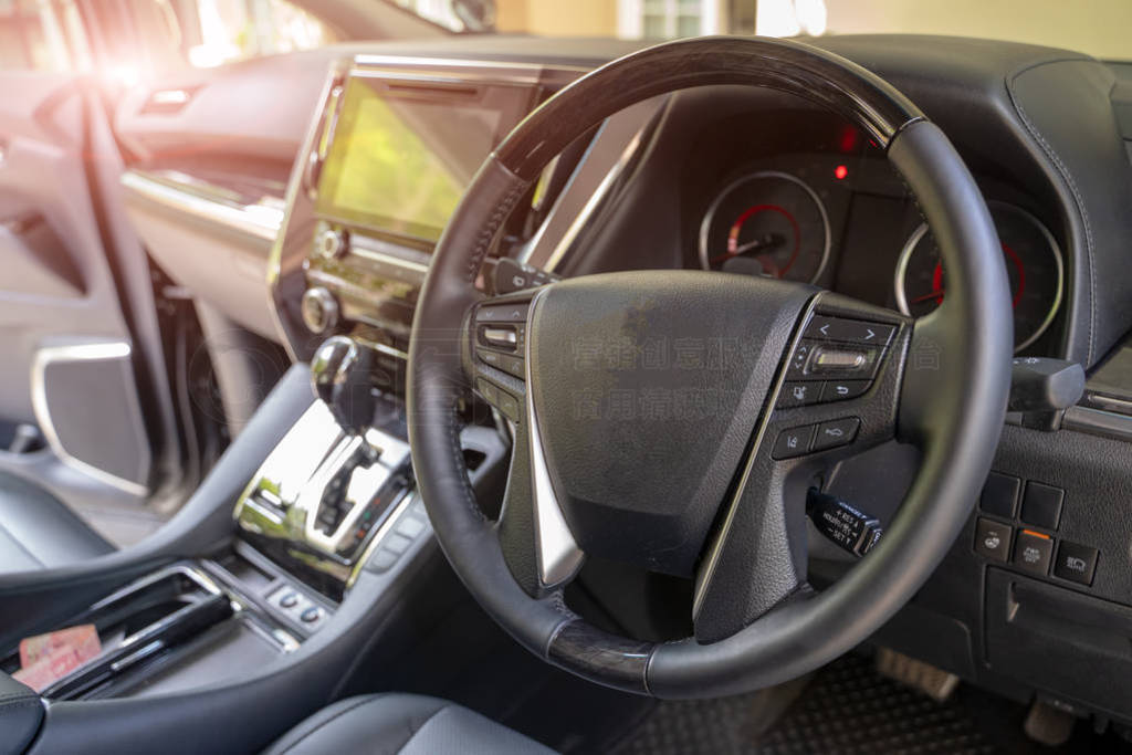 Dark car Interior - steering wheel, shift lever and dashboard.