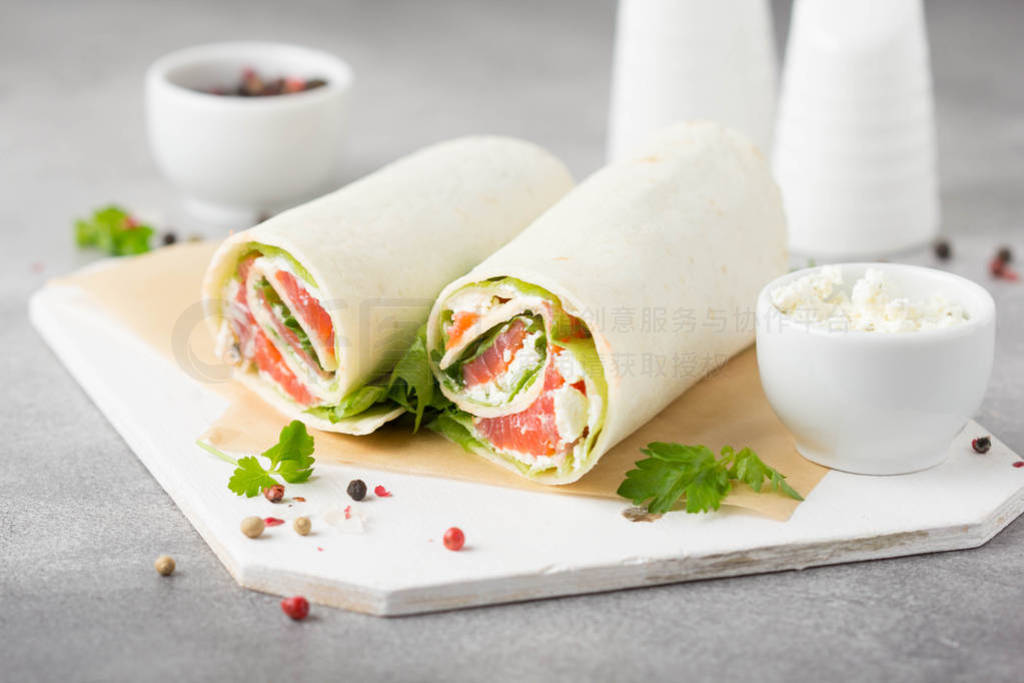Tortilla with salmon, lettuce and cream cheese. Delicious snack