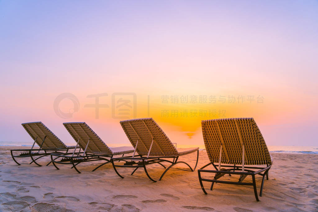 Empty chair on the tropical nature beach and ocean sea at sunris