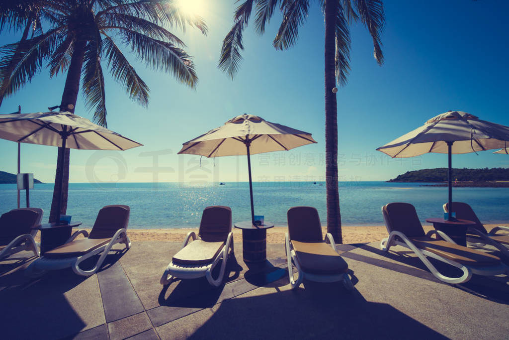 Beautiful tropical beach and sea with umbrella and chair around