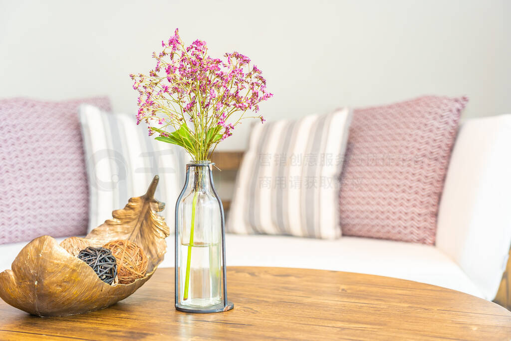 Flower vase on table with pillow on sofa decoration interior of