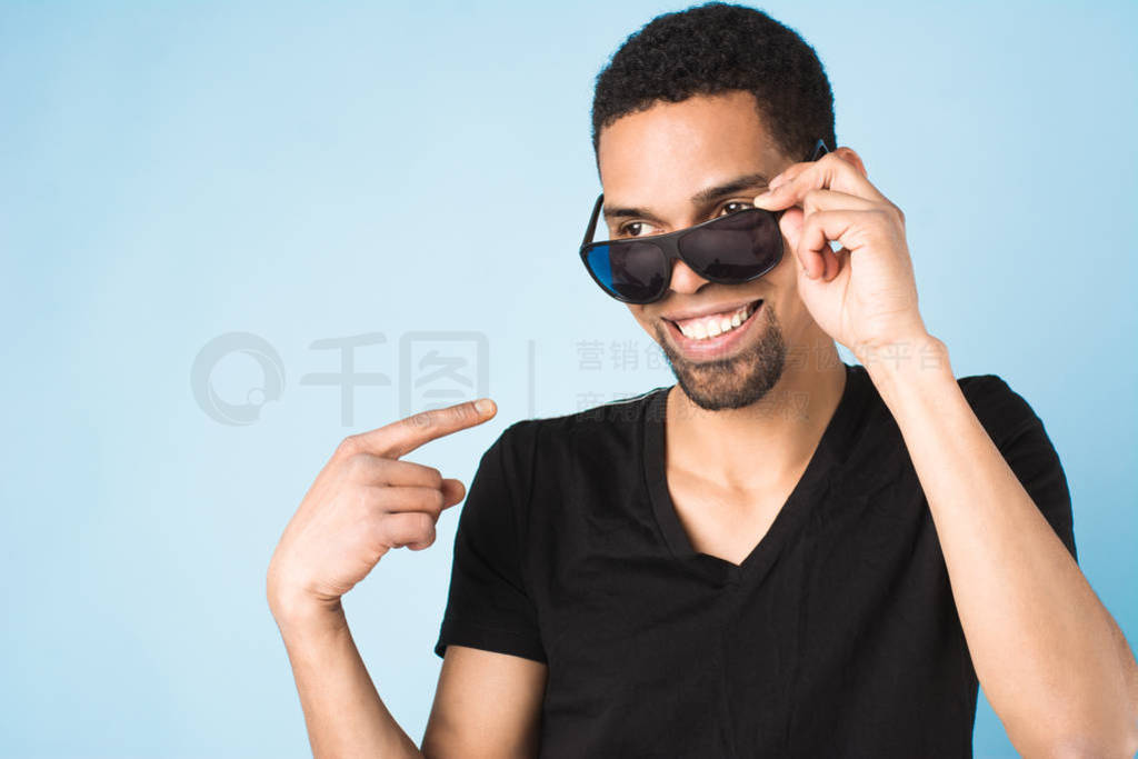 afro american guy in black t-shirt and sunglasses