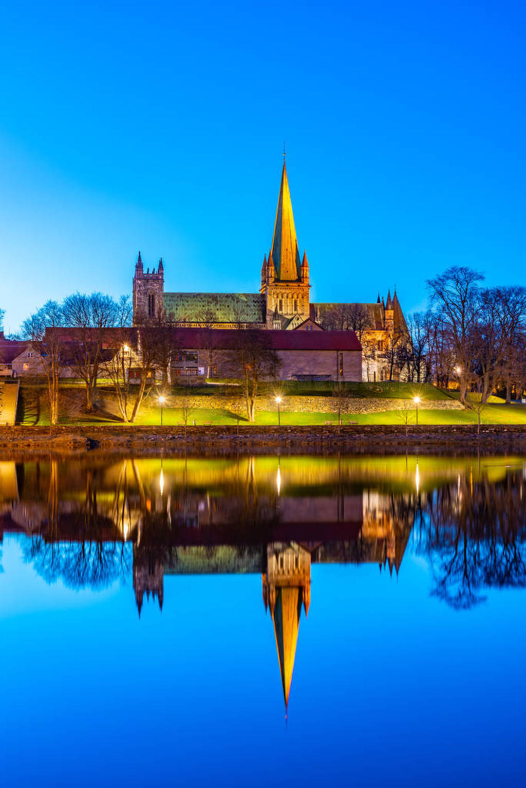 Sunset view of Nidaros cathedral reflecting on river Nidelva in