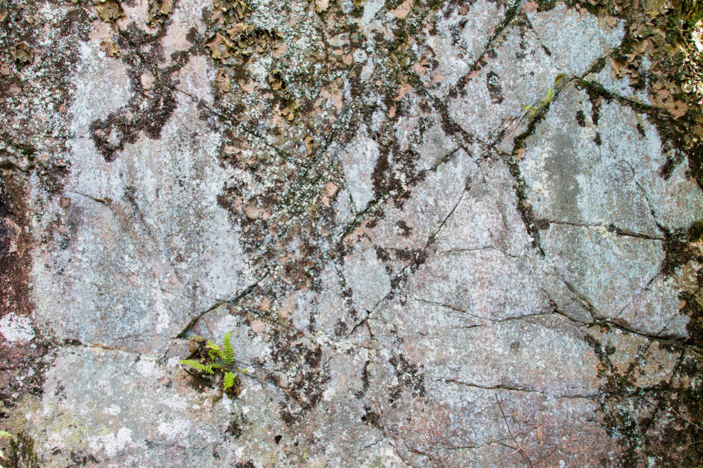 Background, fragment of a rock with cracks