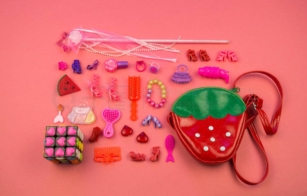 s cosmetics and jewelry Flat lay toys on pink background. View f