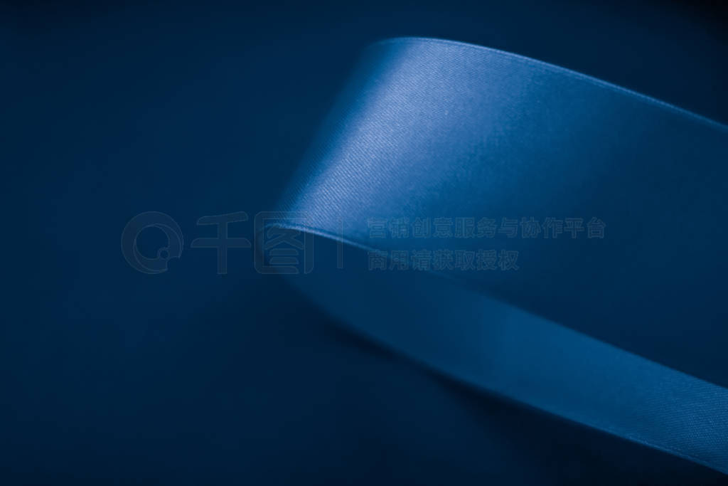 Abstract silk ribbon on royal blue background, exclusive luxury