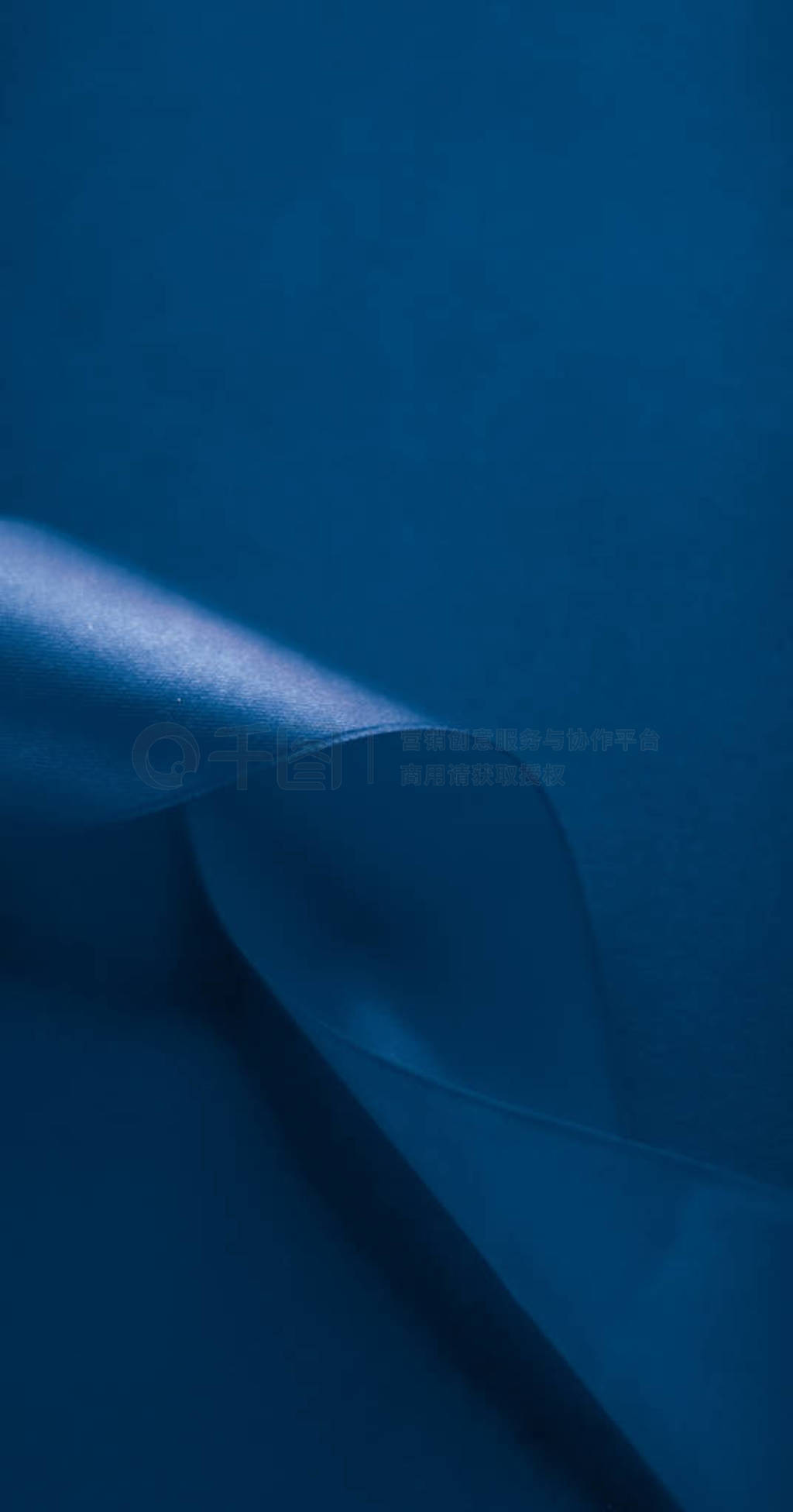 Abstract silk ribbon on royal blue background, exclusive luxury