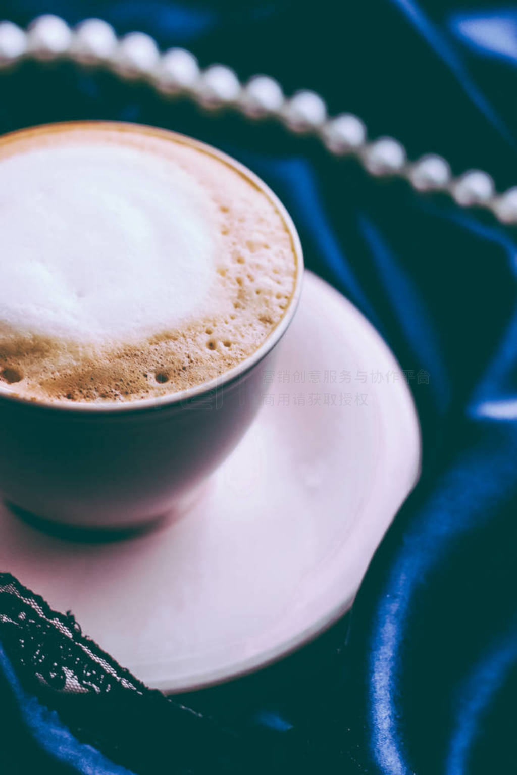 Cup of cappuccino for breakfast with satin and pearls jewellery