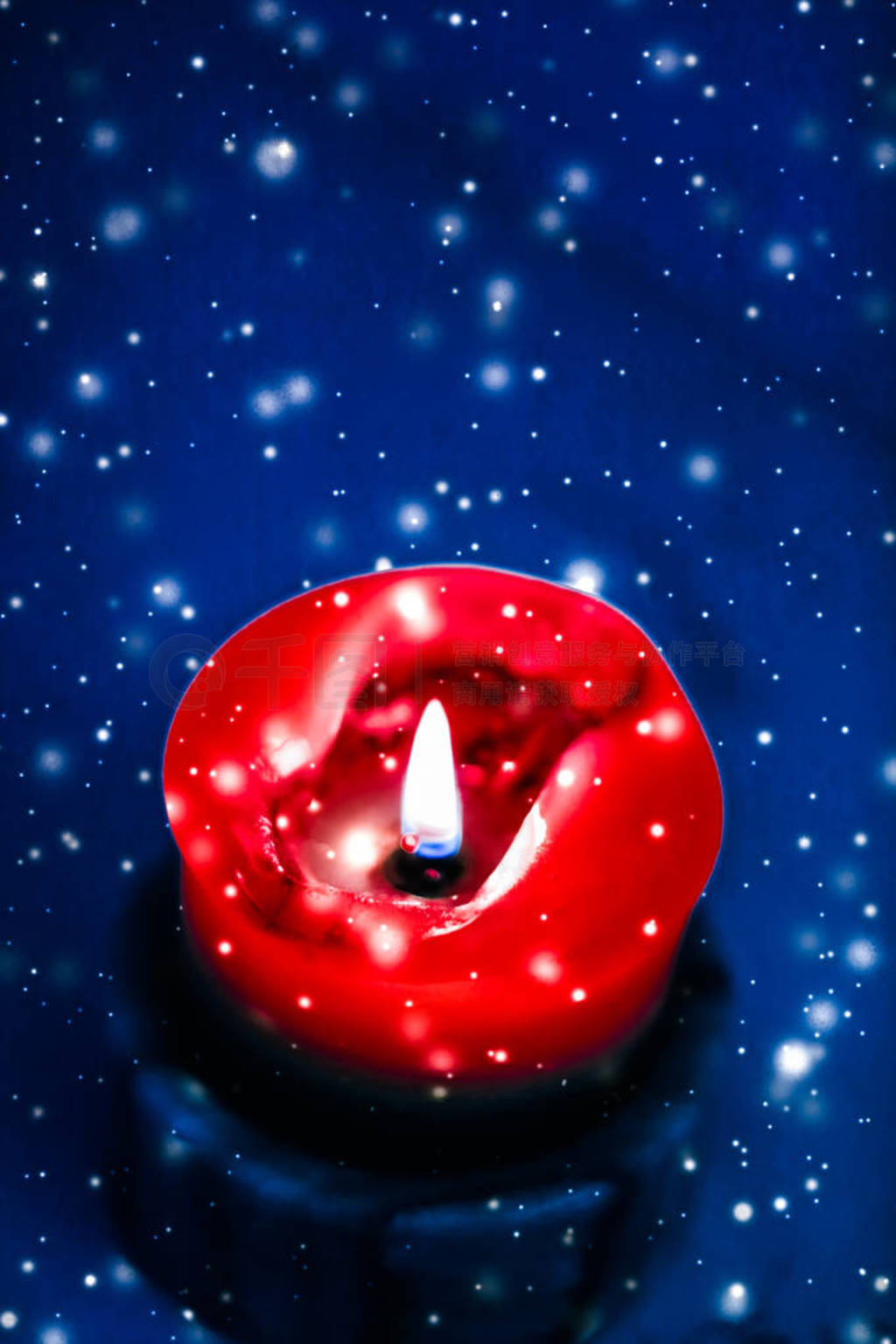 Red holiday candle on blue sparkling snowing background, luxury