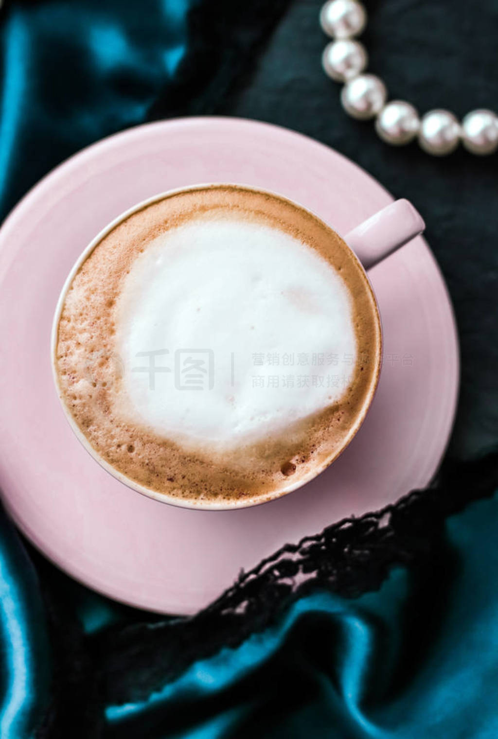 Cup of cappuccino for breakfast with satin and pearls jewellery