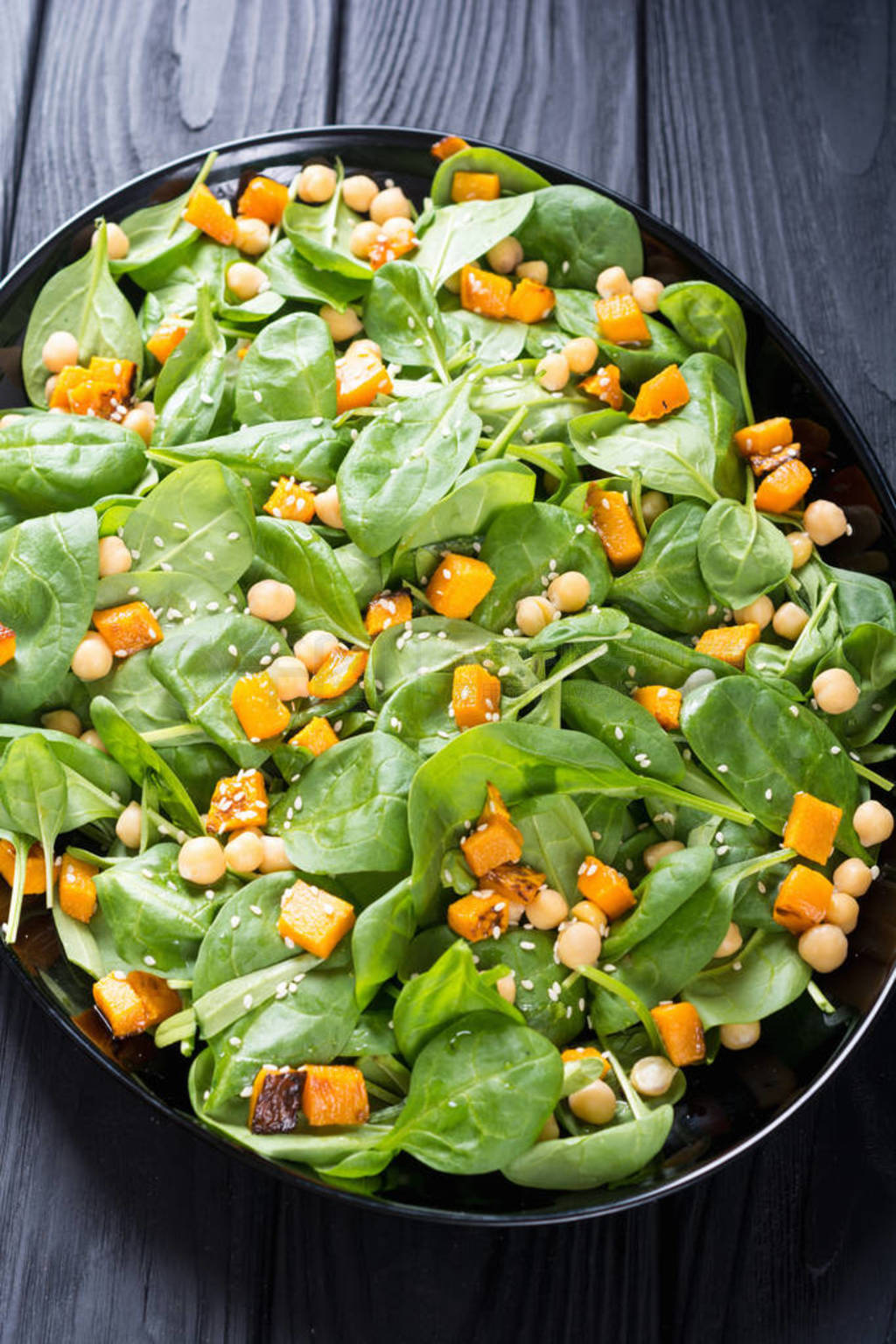 autumn salad with pumpkin , spinach , chickpea and sesame