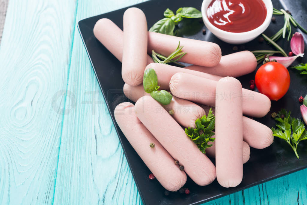 Raw beef sausages with pepper , herbs and ketchup