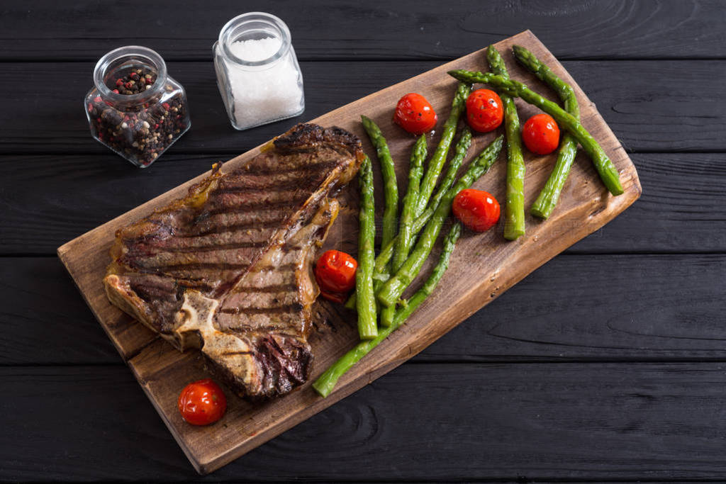 Grilled T-bone steak with asparagus and cherry tomatoes