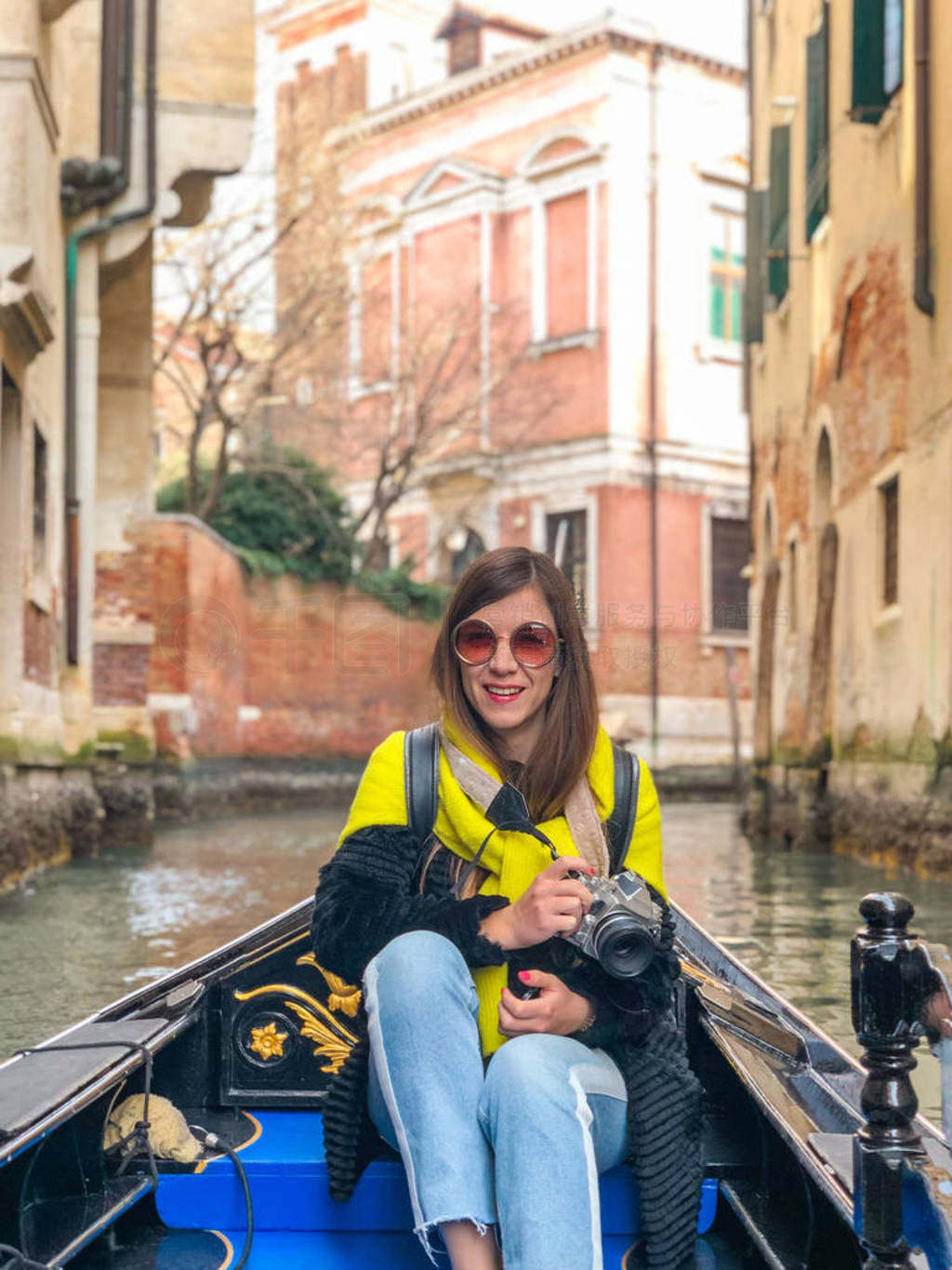 A young woman enjoys a gondola ride and making photo in the cana
