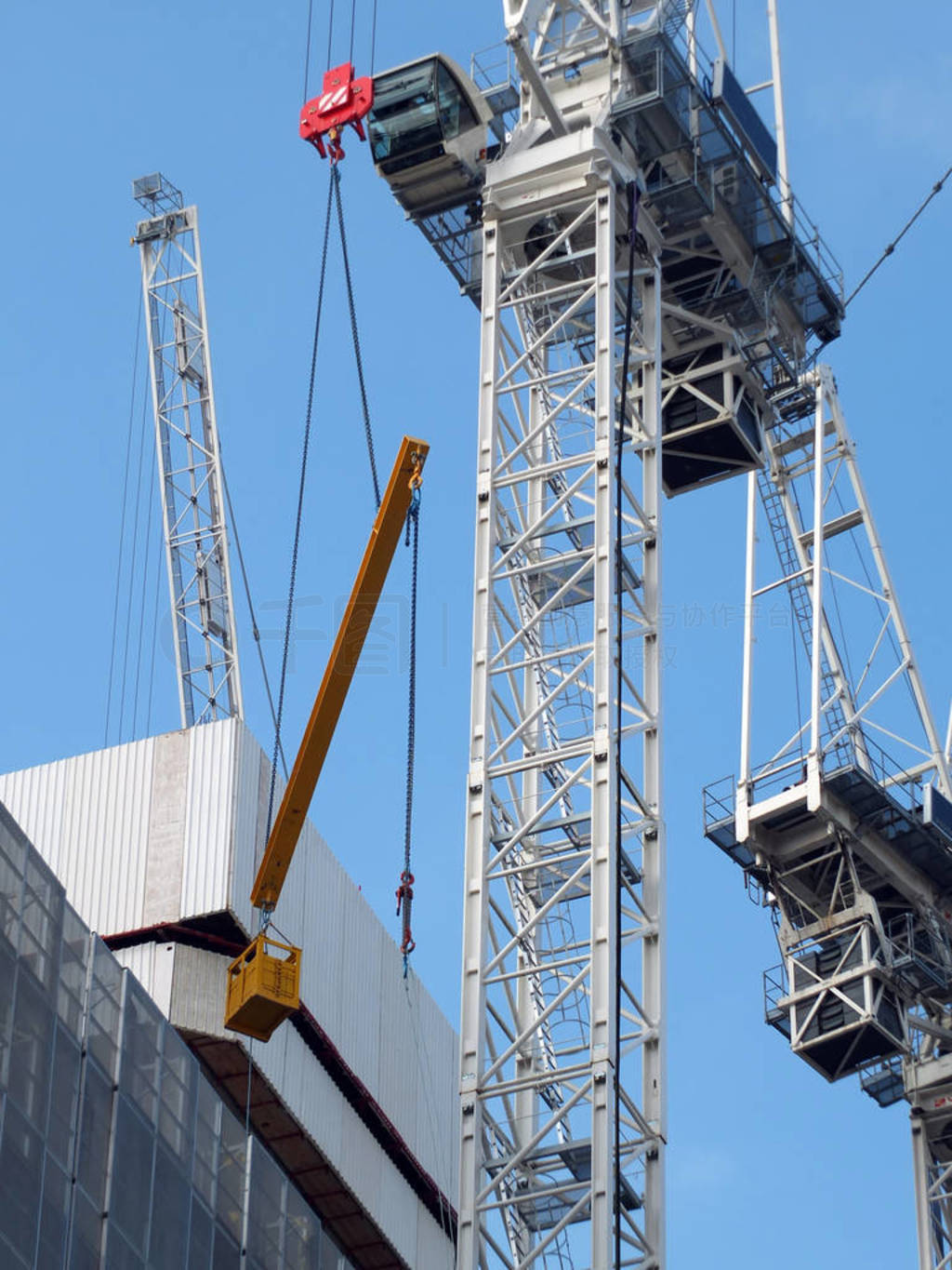 detail of a large construction crane lifting a large metal beam