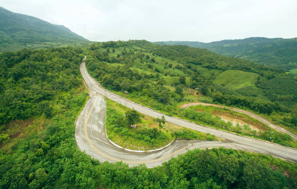 Road heading to the beautiful mountain with car shelter.