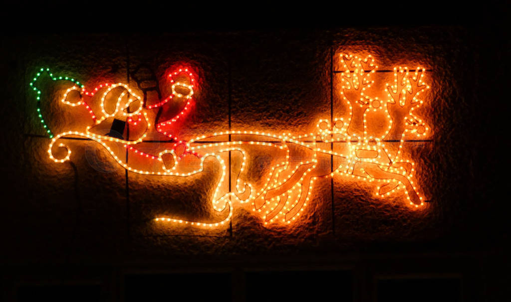 Illumination Santa Claus sleigh with reindeers at christmas in