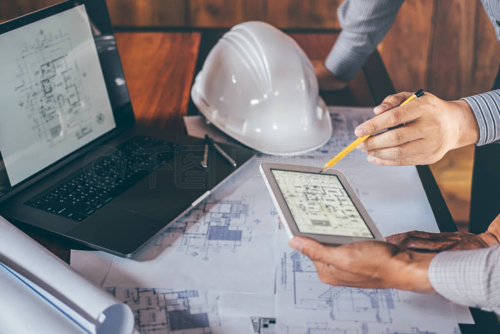 Construction engineering or architect discuss a blueprint while