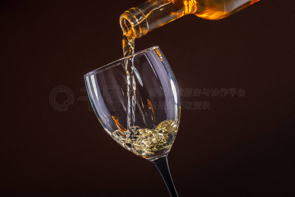 white wine pouring glass