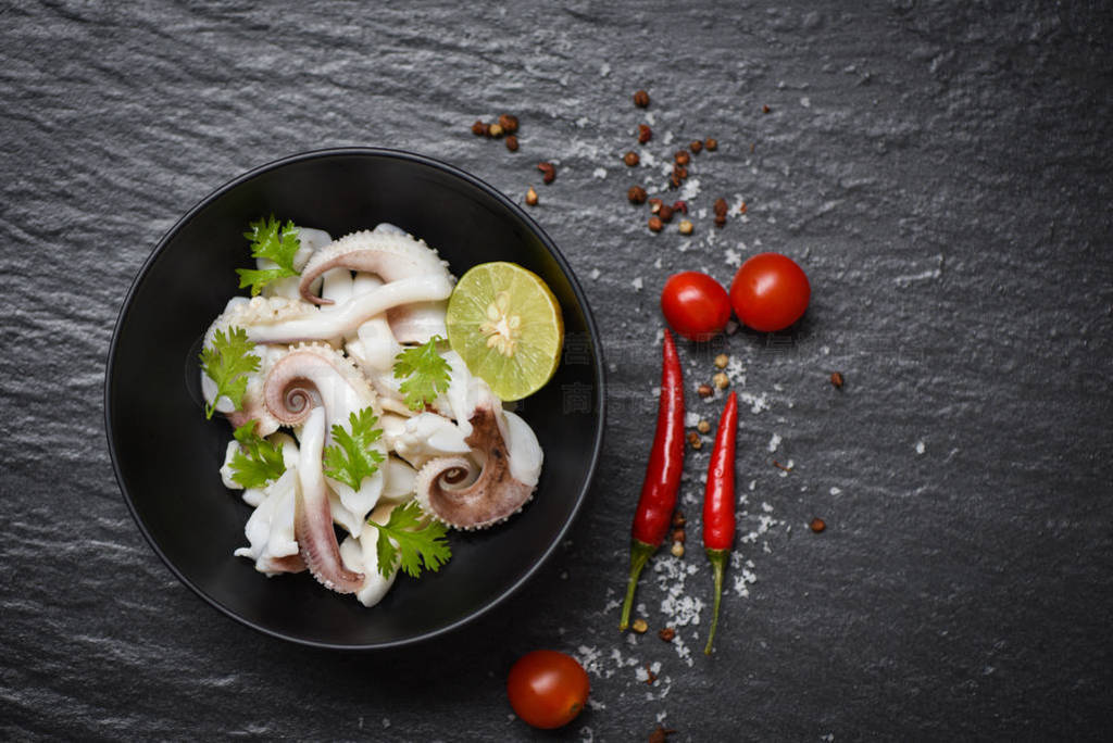 squid salad bowl with lemon herbs and spices on dark background