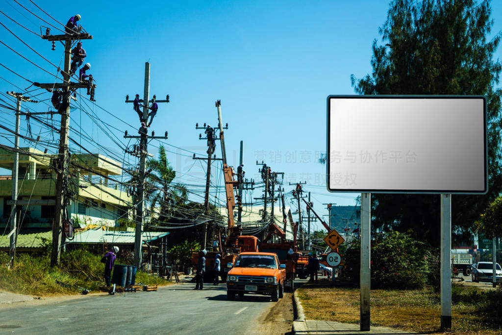 Electricians working on a power pole, filled with complex commun