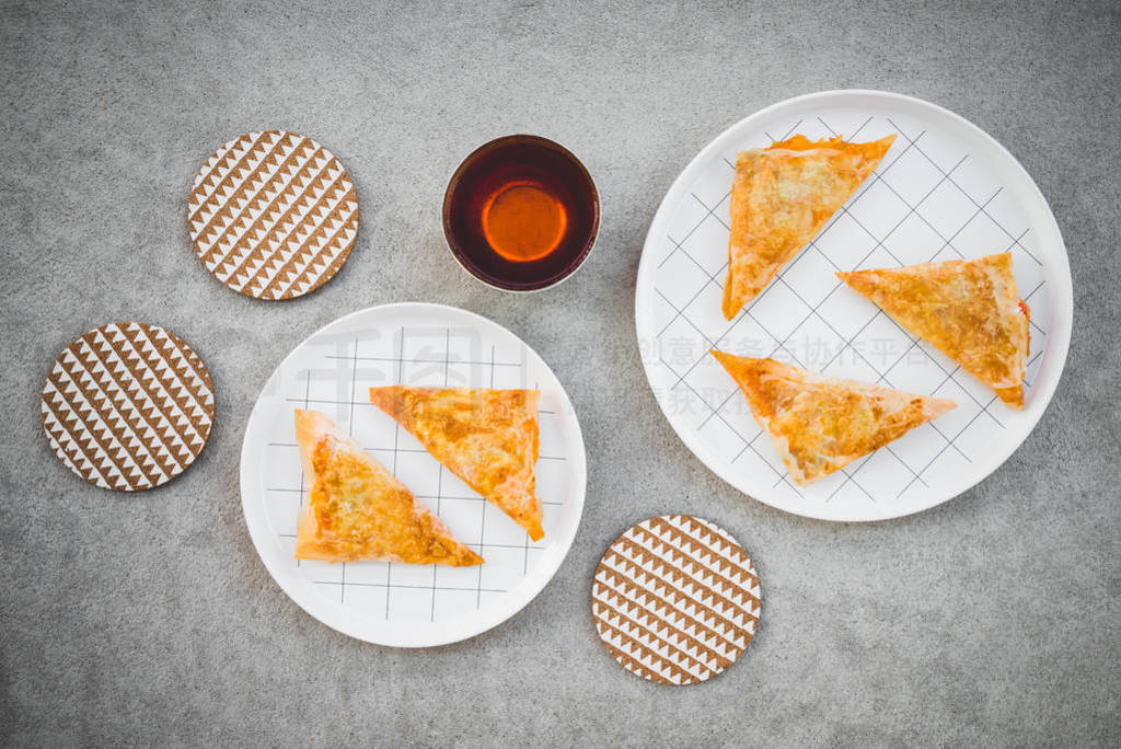 Cheese pies and cup of tea on concrete background