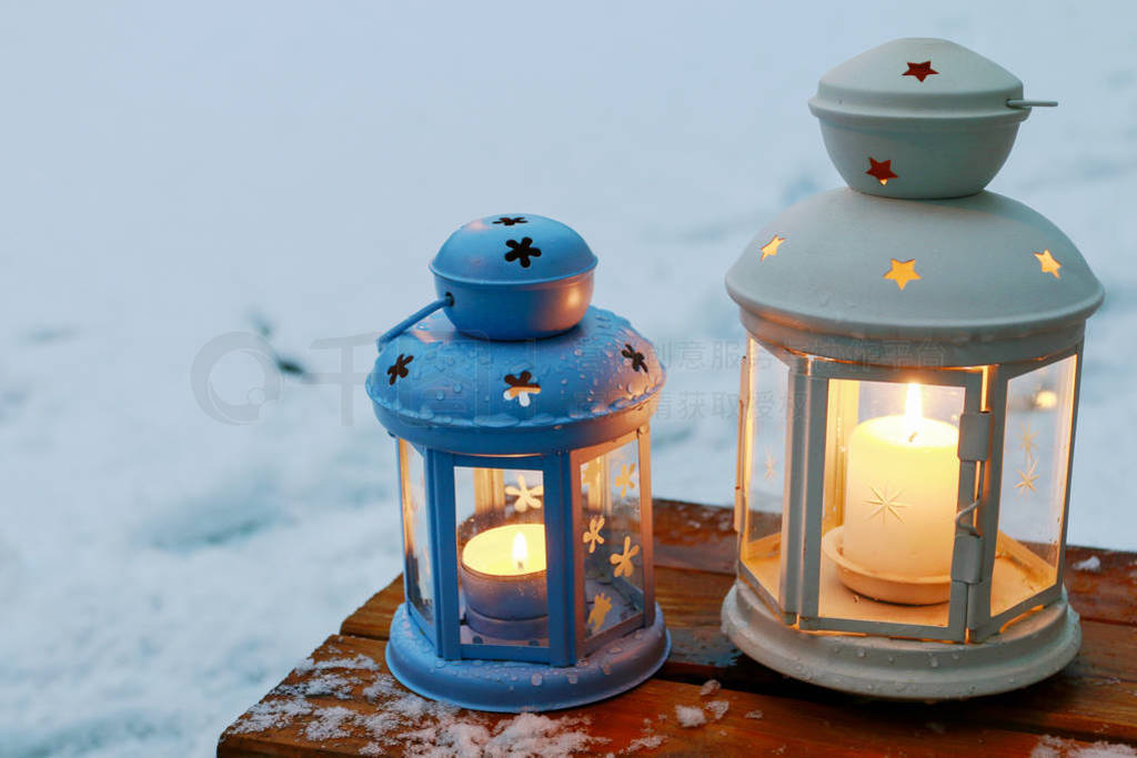 Lanterns in winter snowy garden.