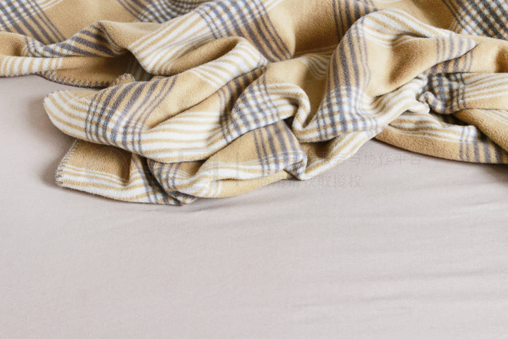 Beige blanket and bedsheet.