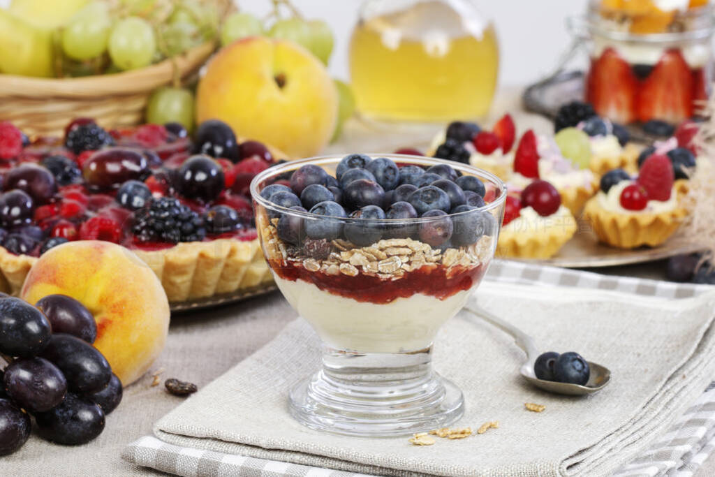Layer fruit dessert in glass container. Summer party.