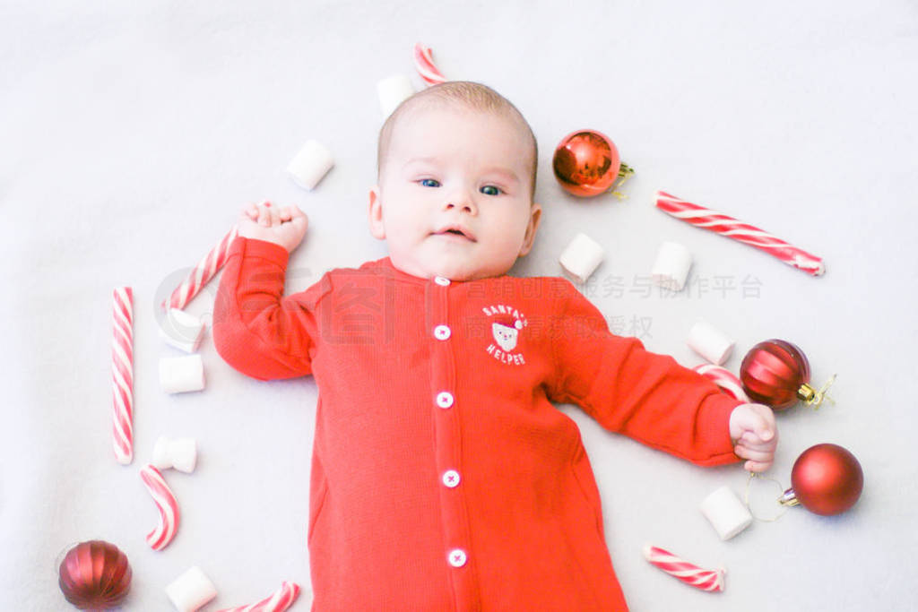 s holidays. Baby with Christmas candy and marshmallows . Santa b