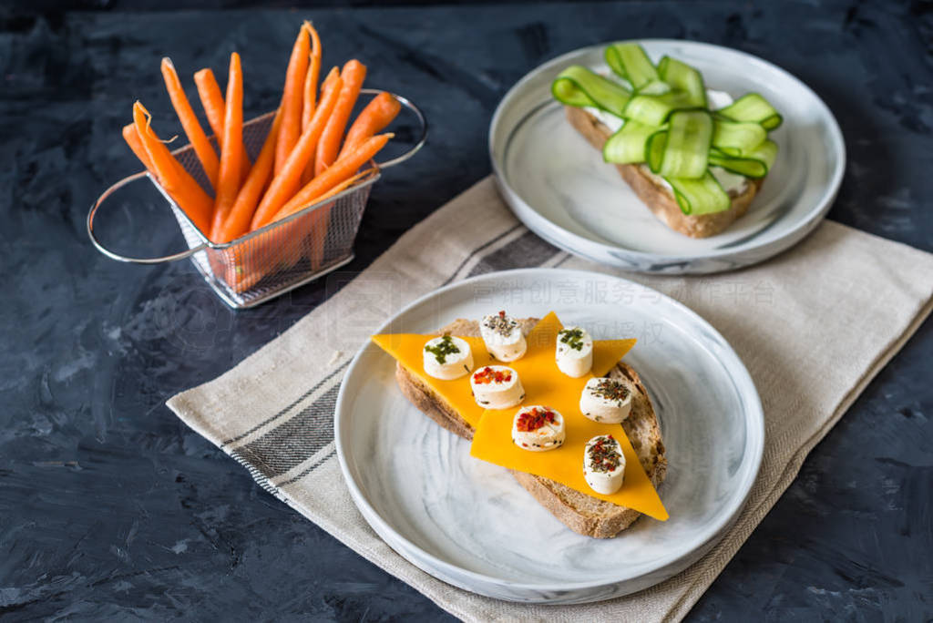 Healthy open sandwiches with vegetables , carrots , cheddar chee