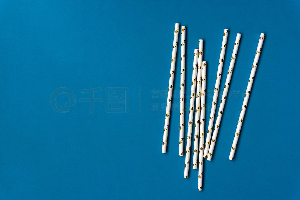 Elegant White Paper Drinking Straws with Golden Stars on blue ba