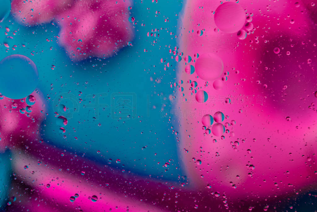 Micro molecular abstract pattern of colored oil bubbles on water